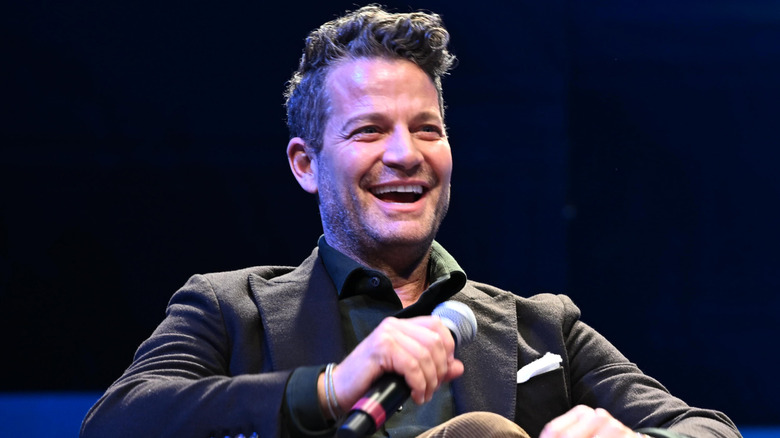 Nate Berkus smiling on stage at a presentation