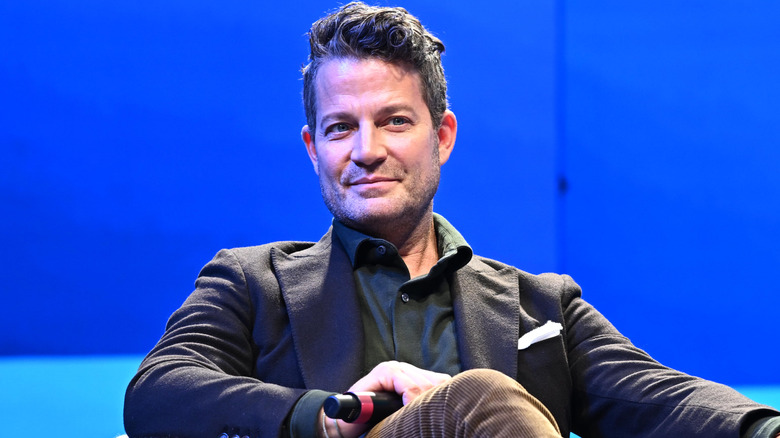 Nate Berkus sitting on chair and smiling