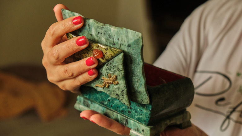 Person holding stone box