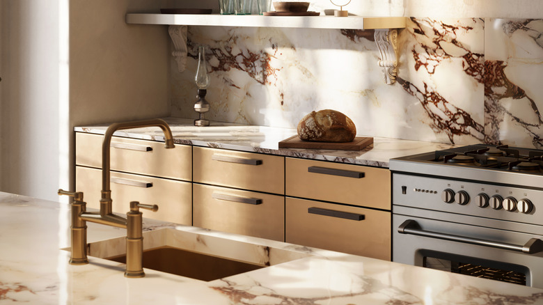 A kitchen with marble countertops and backsplash.