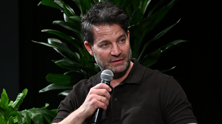 Nate Berkus holding a microphone.