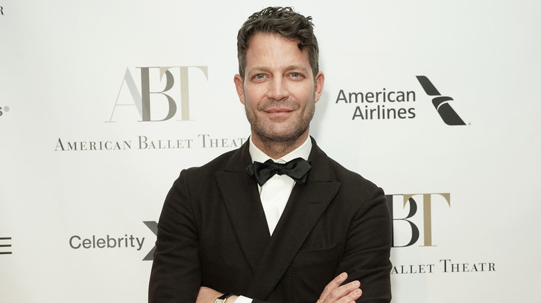 Nate Berkus smiling with arms crossed