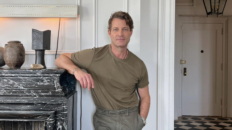 Nate Berkus poses inside a lavish home with neutral tones.
