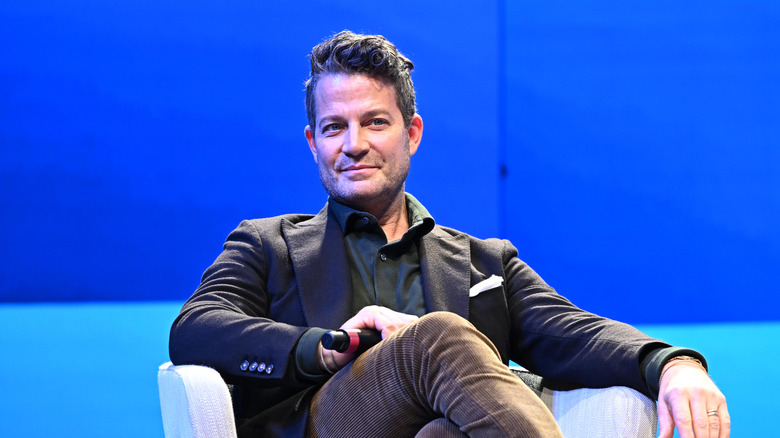 Nate Berkus sitting on chair and smiling