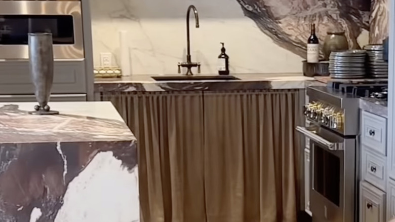 Beige cafe curtain spotted below the kitchen counter in Nate Berkus's office.