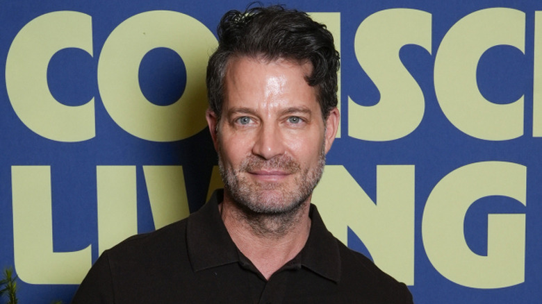 Nate Berkus poses on a red carpet in 2025