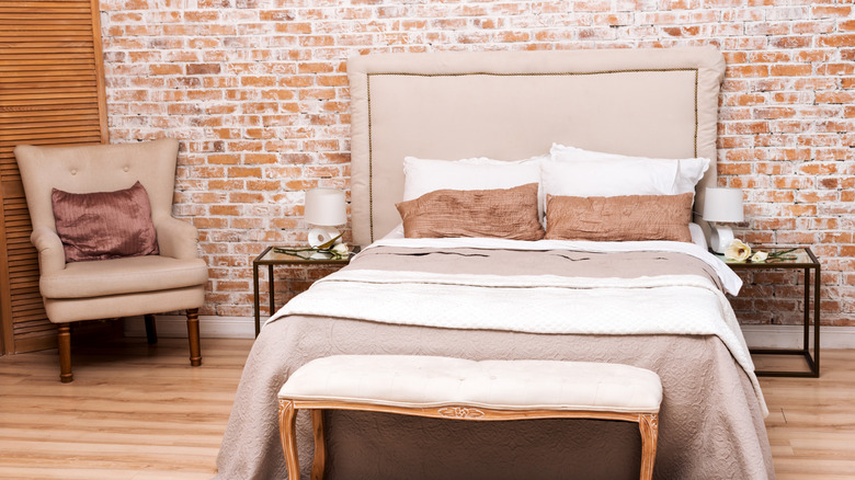 Bedroom with small armchair and upholstered bench