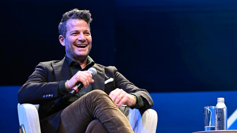 Nate Berkus smiling on stage at a presentation