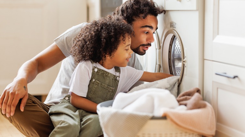 father and son doing laundry