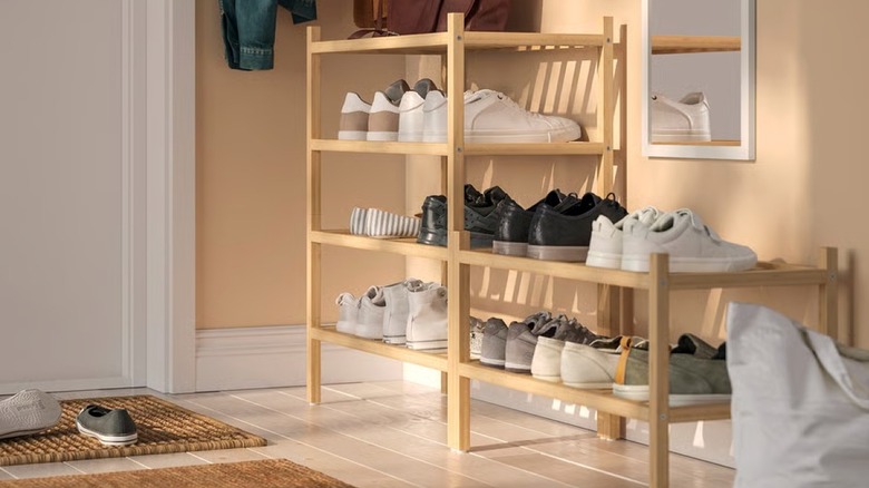 A wooden IKEA shoe rack in an entryway
