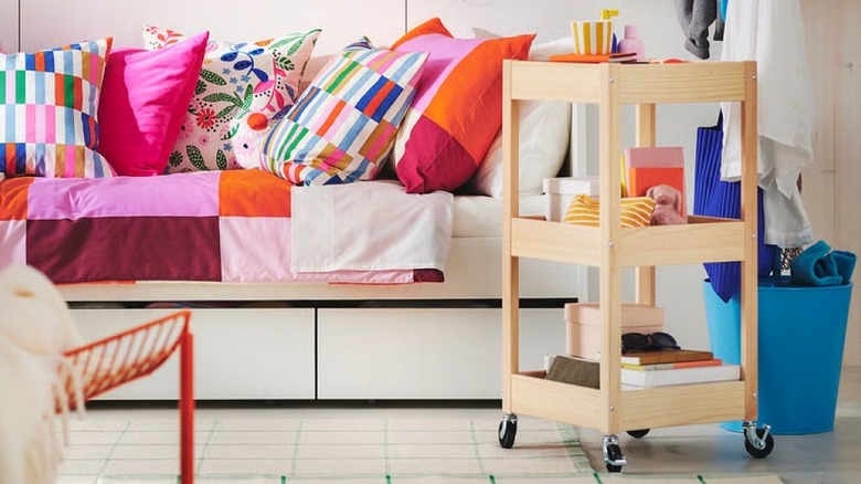 A bright room with a pine rolling cart from IKEA