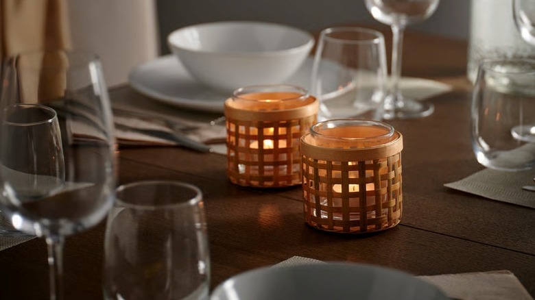 Two bamboo tealight holders on a table with place settings