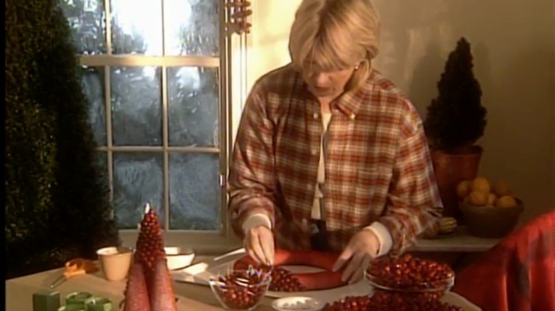 Martha Stewart working on a cranberry wreath