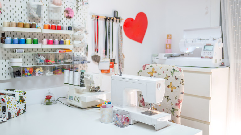 A bright and organized craft room with thread and sewing machines