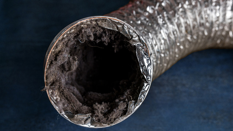 A dryer vent with lots of lint buildup inside it