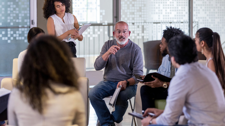 People sitting in a circle at a HOA meeting