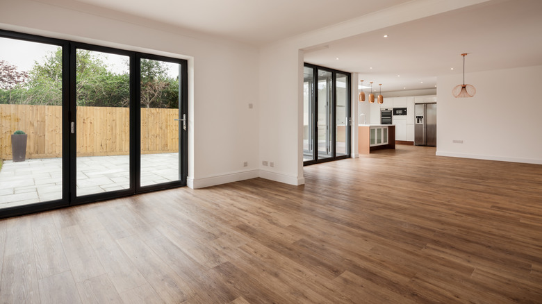 A modern home interior with an open floor plan and glass patio doors