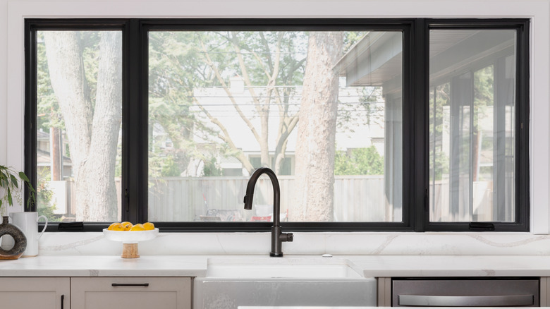 A kitchen window with no window treatment.