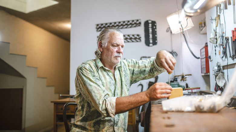 Man working at tool bench in home