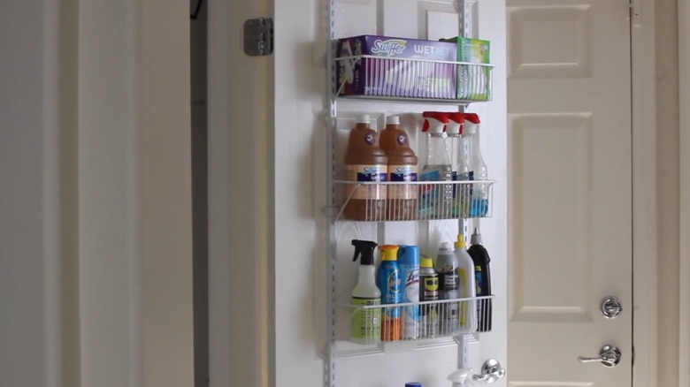 Cleaning supply storage on the back of a closet door