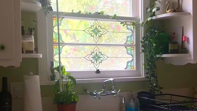Kitchen window with stain glass appliques on bottom panel.