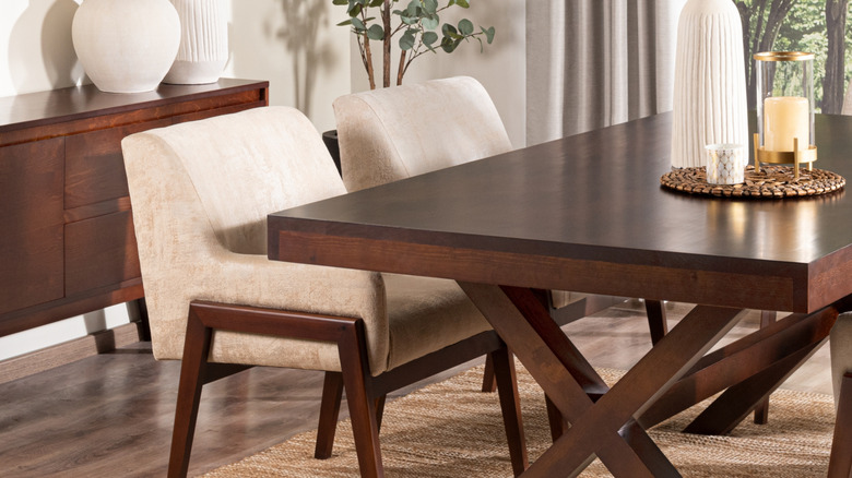 Stylish dining room with dark wooden sideboard and dining table