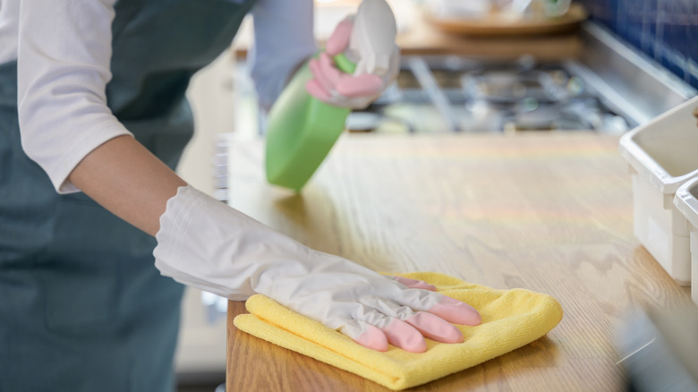 Person wiping down counter