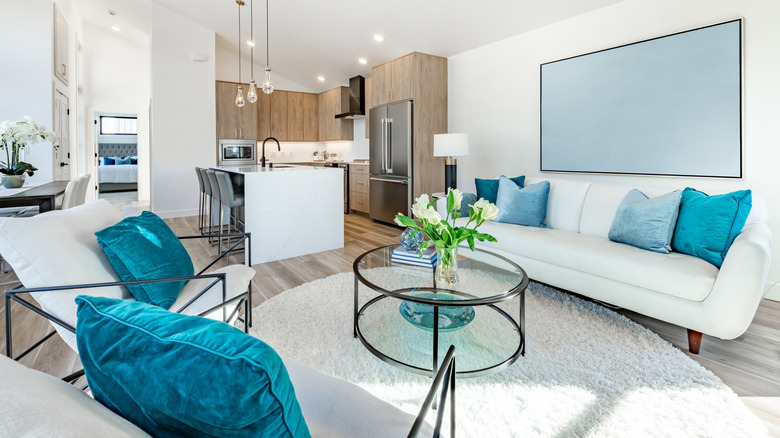 Modern white living room with electric blue accent pillows