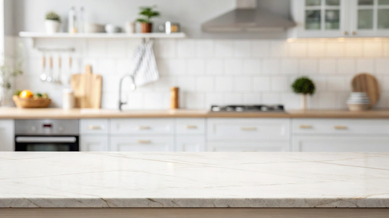 A kitchen with a white counterop