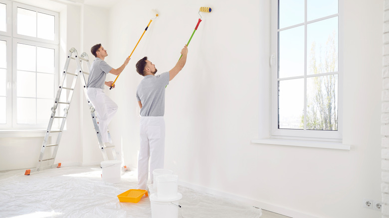 Workers painting a room