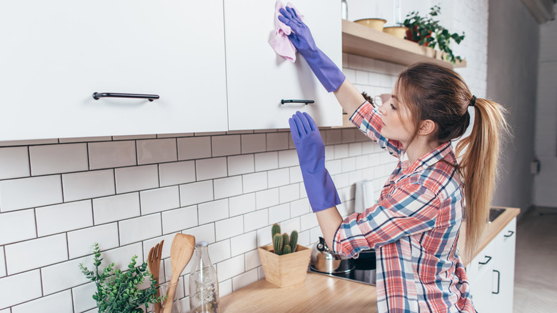 woman cleaning cabinets