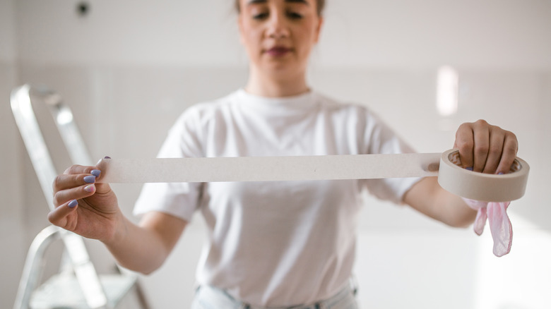 woman unrolling tape