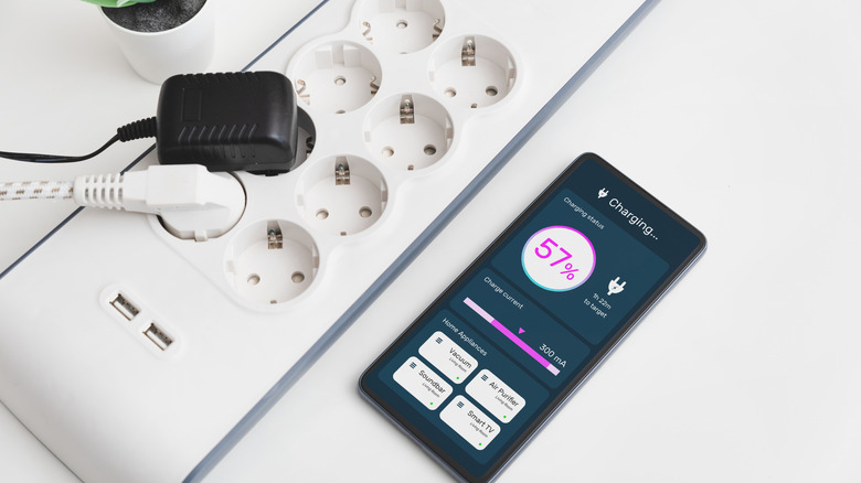 charging a phone next to a smart power strip