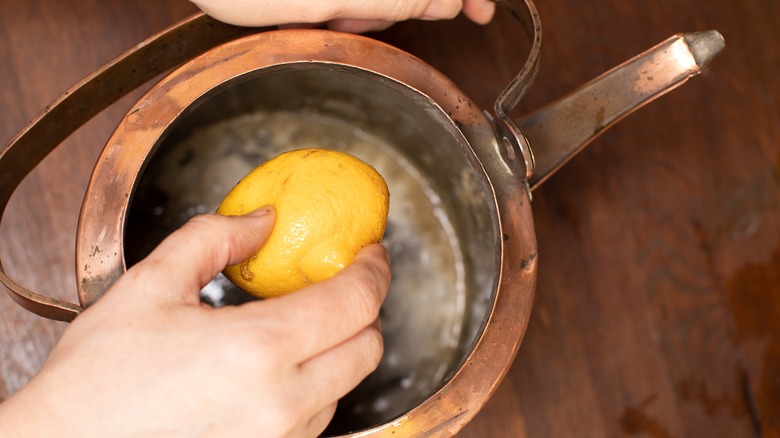 Cleaning copper cookware with lemon