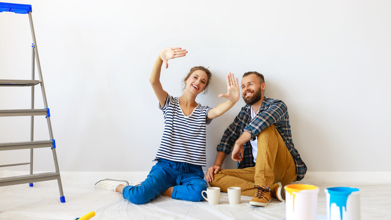 Couple painting house