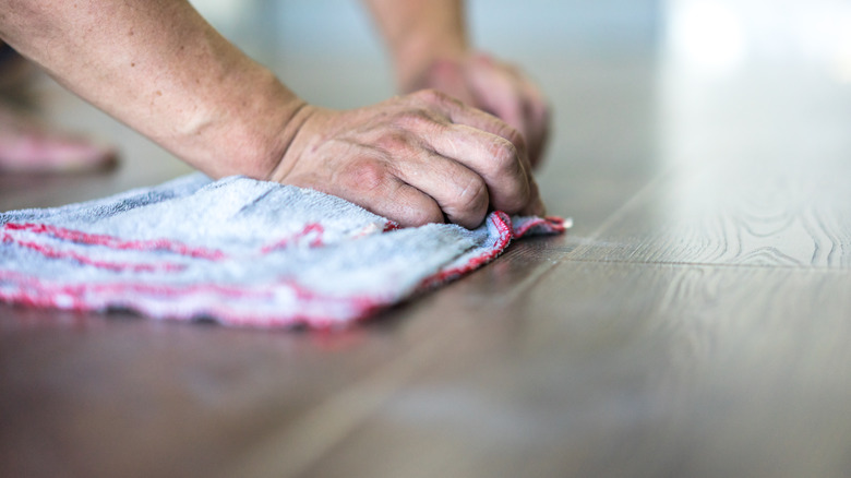 A person cleaning a floor 