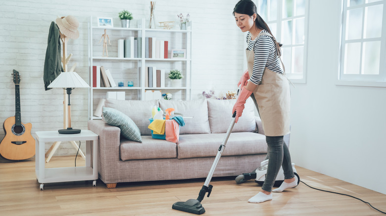 A woman using a vacuum cleaner 