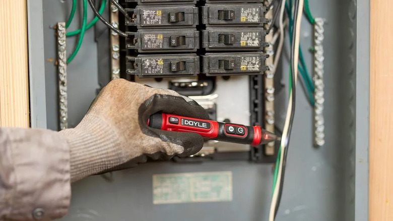 A person using the new Doyle noncontact voltage tester to test a live wire