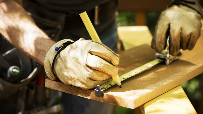 Builder holding carpenter pencil