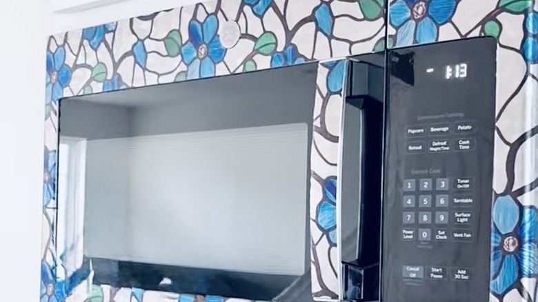 Microwave covered in decorative cling film