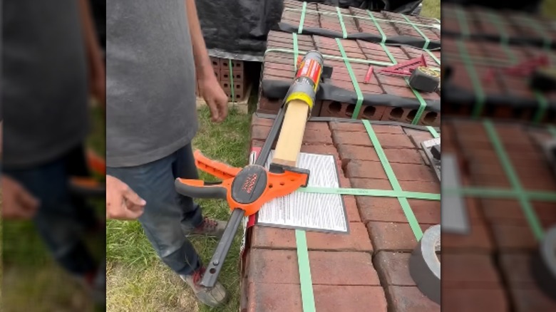 Man demonstrating DIY caulk gun