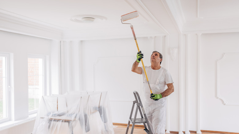 man painting ceiling