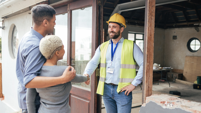 couple speaking to contractor