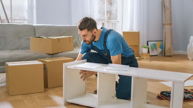 man assembling shelving unit