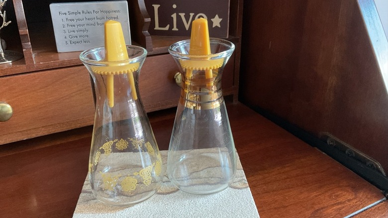 vintage clear glass salt and pepper shakers on a desk