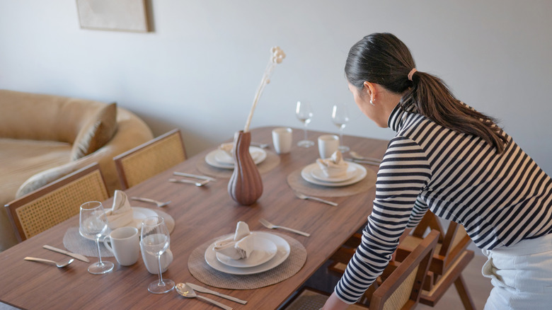 woman setting dining room table