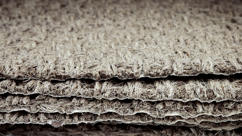 Close up photo of natural material doormats in a pile
