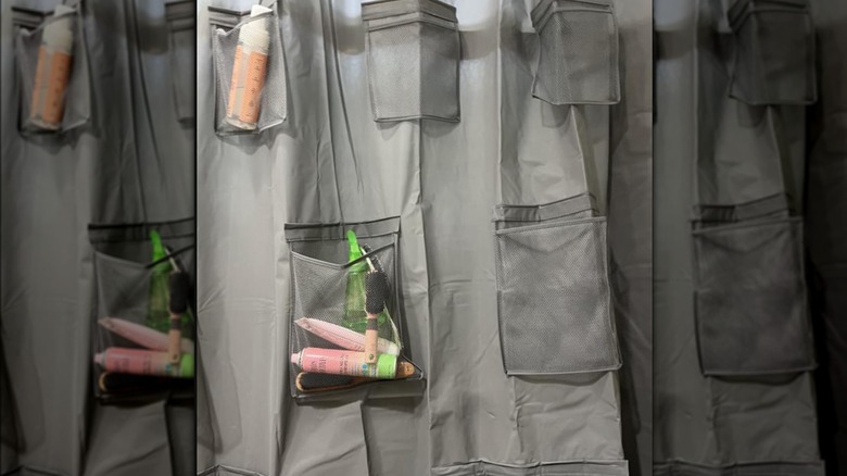 User image of gray shower curtain organizer holding hair products