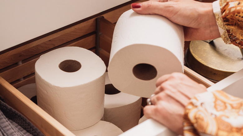 Toilet paper rolls in a bathroom drawer