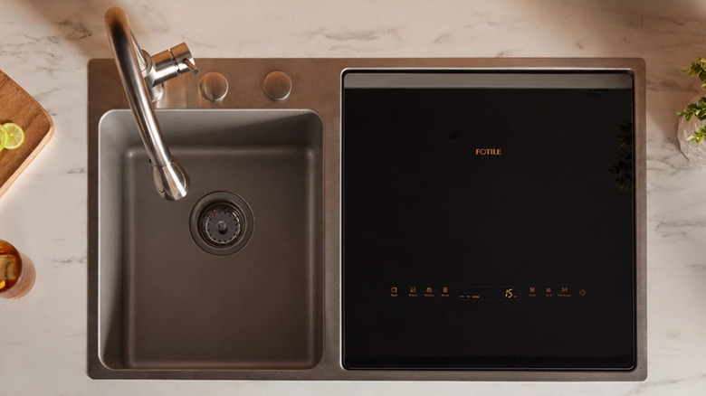 Top down view of the FOTILE 3-in-1 top load dishwasher and stainless steel sink.